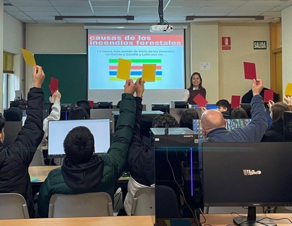 Estudiantes levantando tarjetas en una jornada sobre incendios forestales
