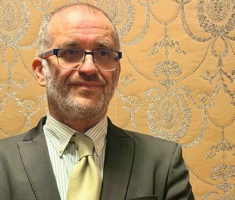 Alfredo López Valdesoiro en un evento formal con fondo decorativo