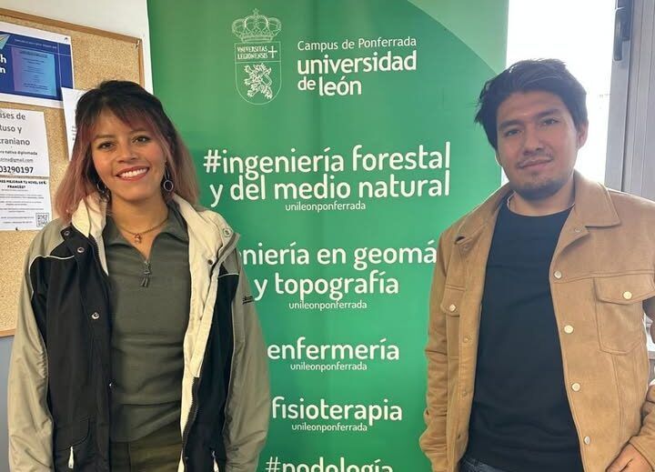 Estudiantes internacionales del Máster en Geoinformática en Ponferrada posando con un cartel de la universidad.