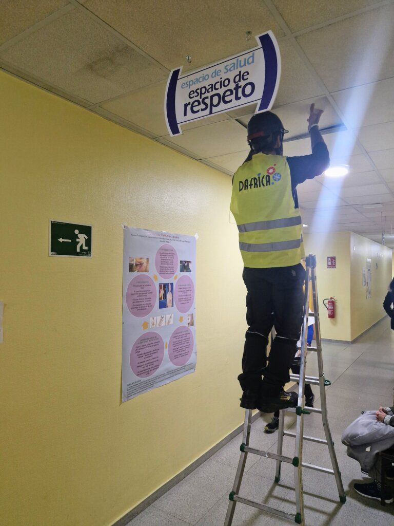 Trabajador instalando señalización en el Centro de Salud de Fabero