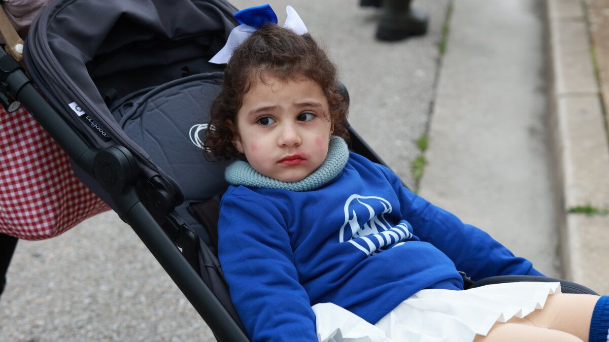 Niña sentada en un carro de bebé durante el carnaval de Ponferrada