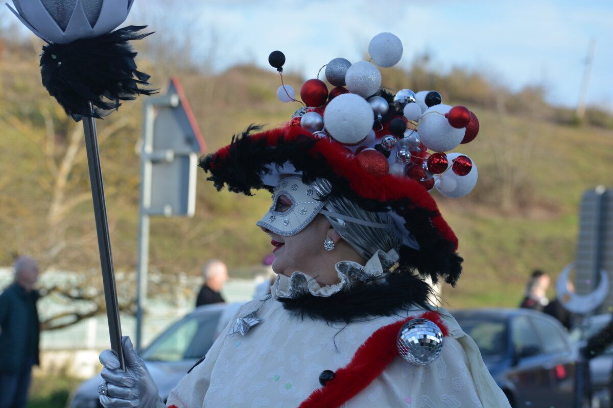 Participante del desfile de Carnaval en Cacabelos con un elaborado disfraz y sombrero