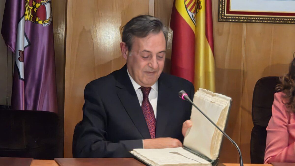 Hombre revisando un libro en un evento del festival del botillo