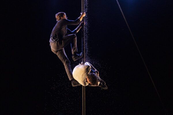 Dos artistas de circo realizando acrobacias en un espectáculo llamado Latas