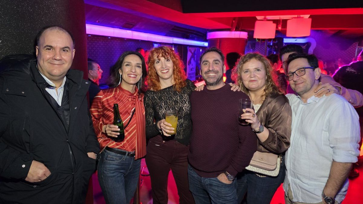 Grupo de amigos disfrutando en una fiesta con luces de colores