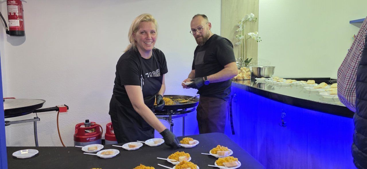 Dos personas sirviendo comida en la inauguración del Bar Sueños en Ponferrada