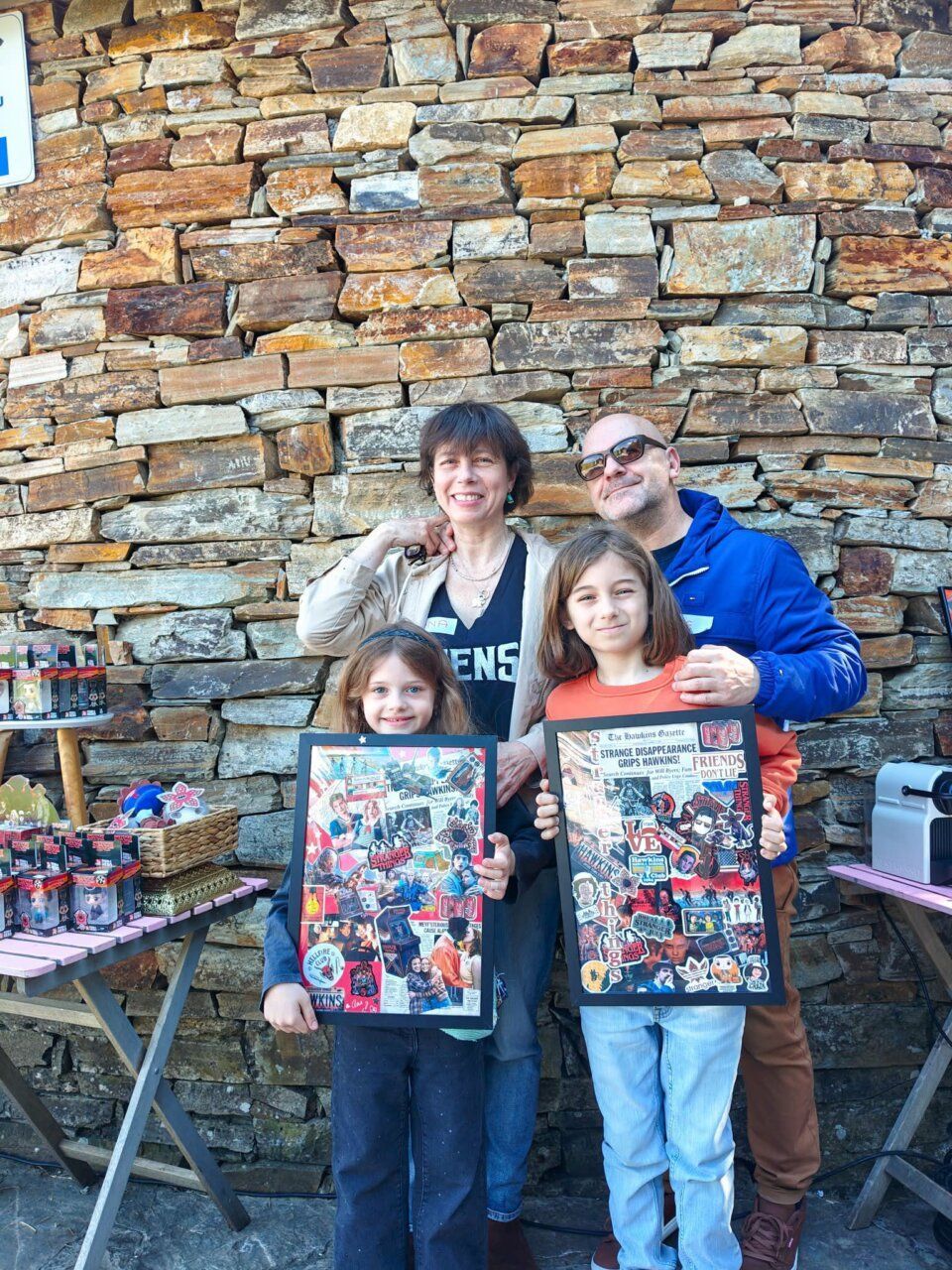 Familia posando con carteles de Stranger Things en Carracedelo