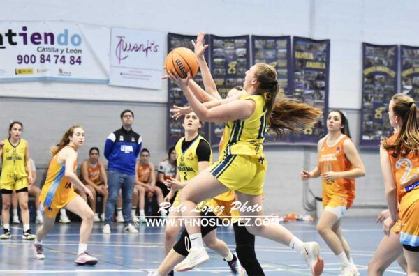 Jugadora de Básquet Coruña lanzando el balón en un partido contra Embutidos Pajariel.