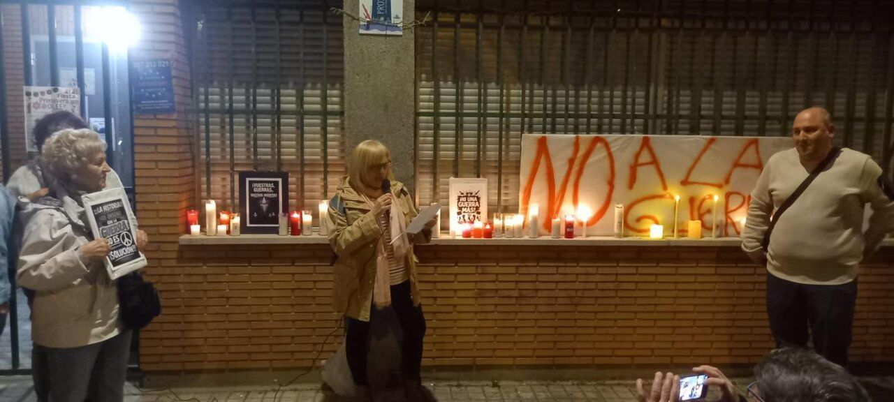Participantes en la marcha por la paz sosteniendo velas y pancartas