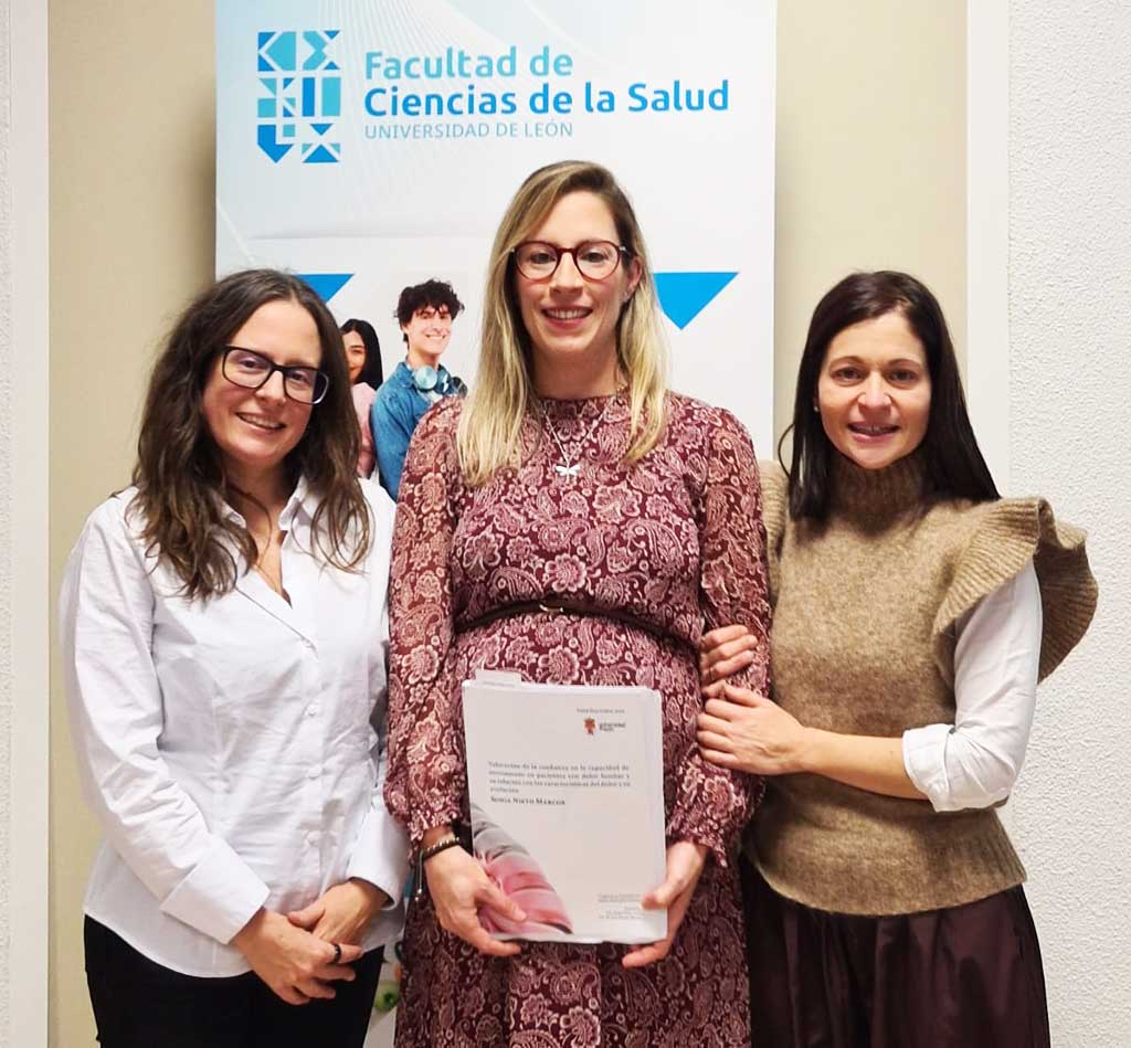 Tres mujeres posando con un documento en la Facultad de Ciencias de la Salud