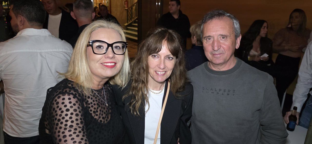 Tres personas posando en una celebración del segundo aniversario del casino