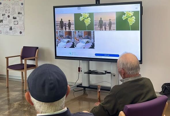 Personas mayores participando en una actividad de estimulación cognitiva con tecnología.