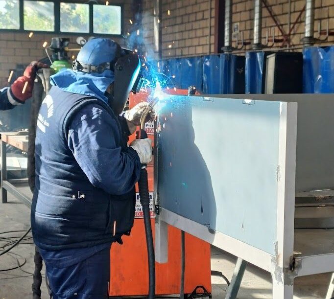 Alumno soldando una estructura metálica para huertos urbanos en Ponferrada