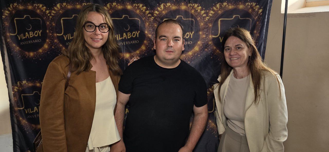 Tres personas posando en el evento del quinto aniversario de Vilaboy Fotografía