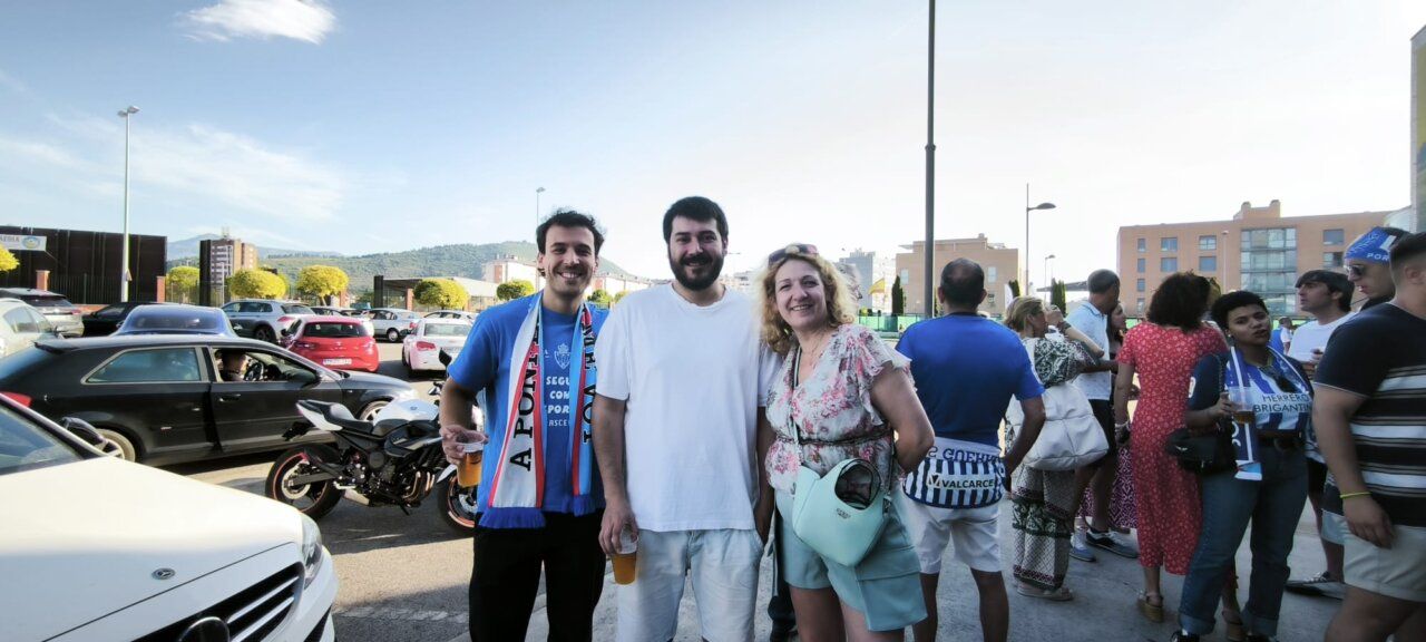 Grupo de amigos en un bar con bufandas de fútbol