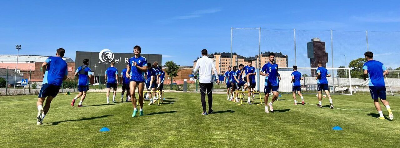 Jugadores de la SD Ponferradina entrenando en el campo bajo un cielo azul