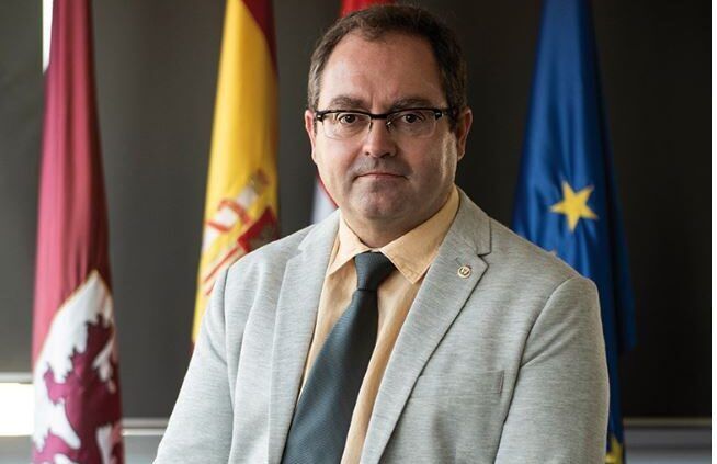 Félix Antonio Barrio Juárez posando en su oficina con banderas