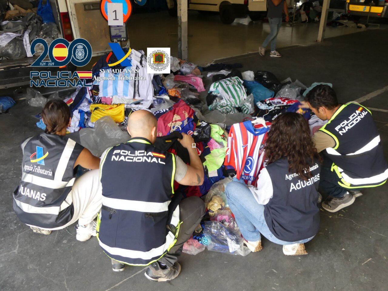 Agentes de la Policía Nacional revisando ropa falsificada en un mercadillo