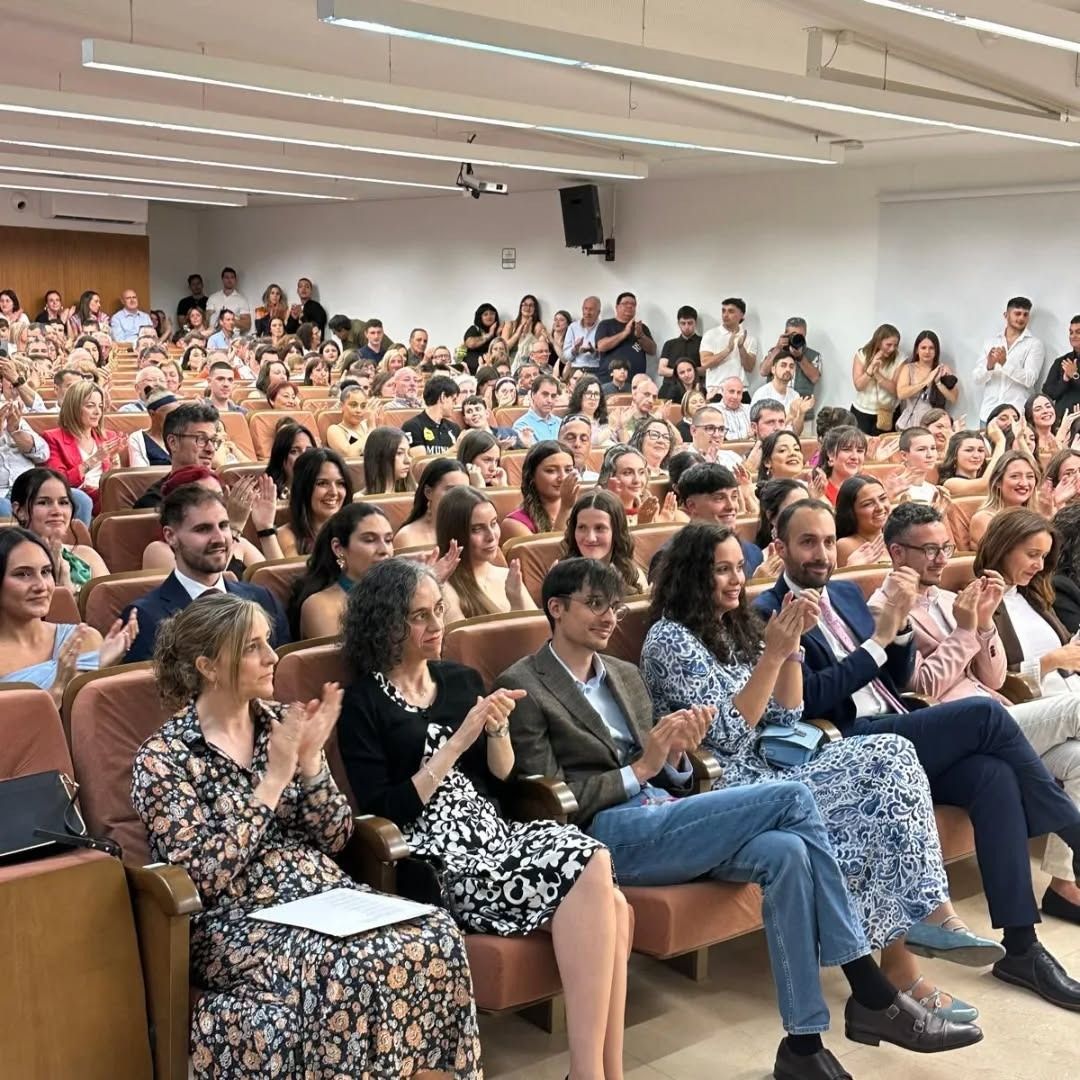 Ceremonia de graduación en el Campus de Ponferrada con estudiantes y familiares aplaudiendo.