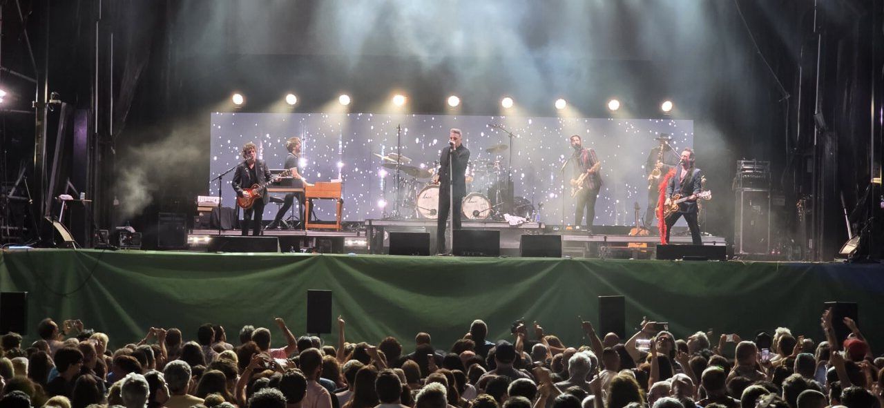 Concierto en vivo con banda tocando en el escenario