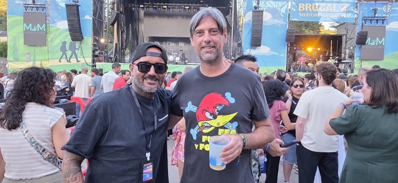 Dos hombres posando en un festival de música al aire libre
