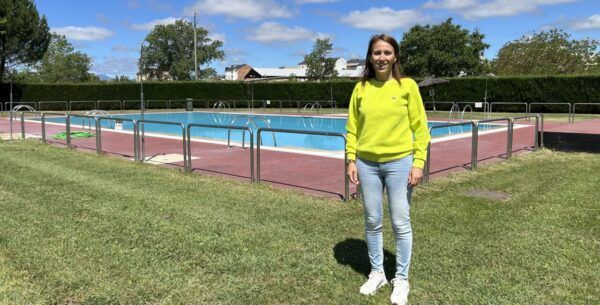 Mujer sonriente junto a piscina municipal en Ponferrada