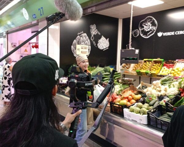 Participante del reality en el Mercado de Abastos de Ponferrada con verduras frescas.