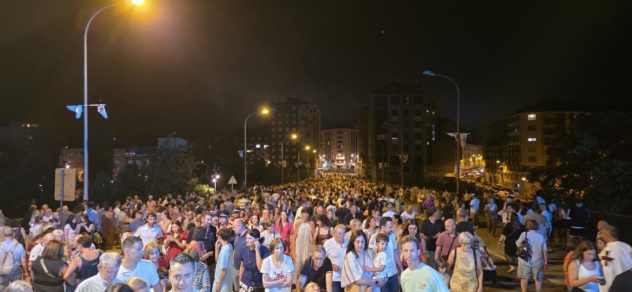 Multitud de personas en un desfile templario nocturno
