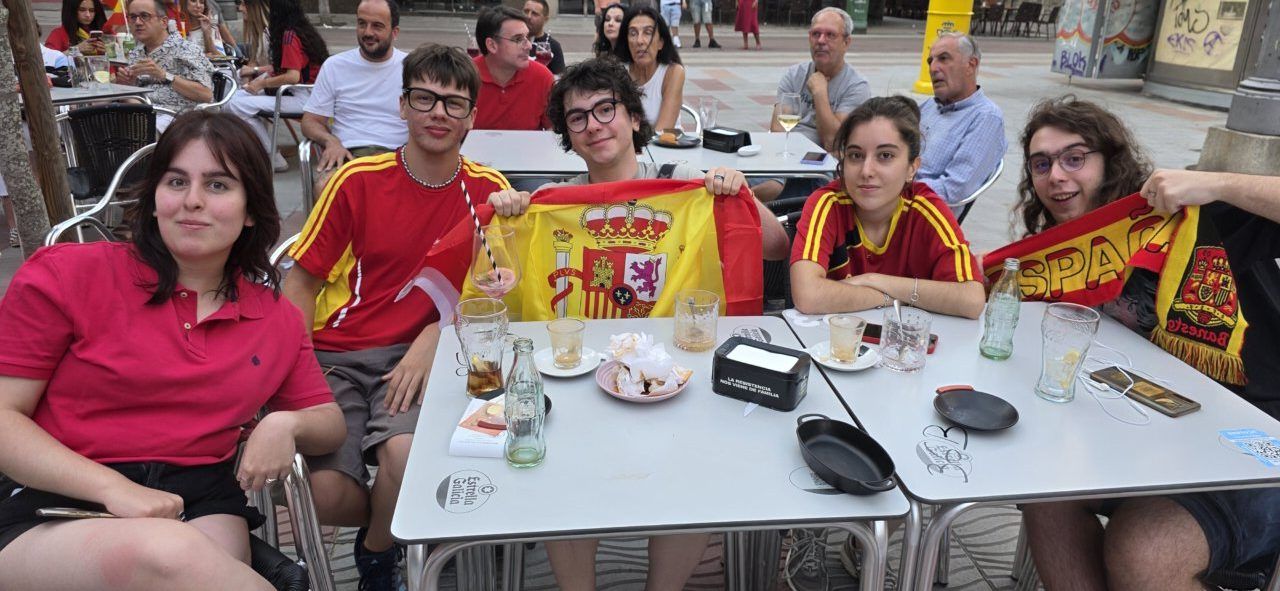 Grupo de jóvenes celebrando la final del Mundial entre España y Argentina en un bar
