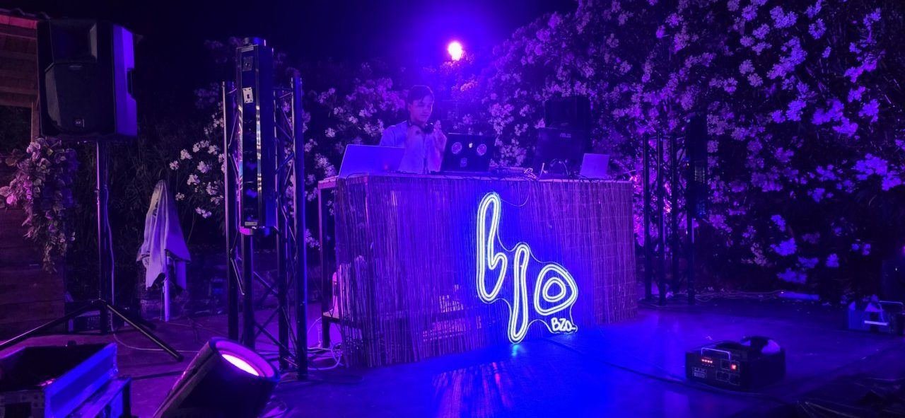 DJ actuando en un evento nocturno con luces de colores