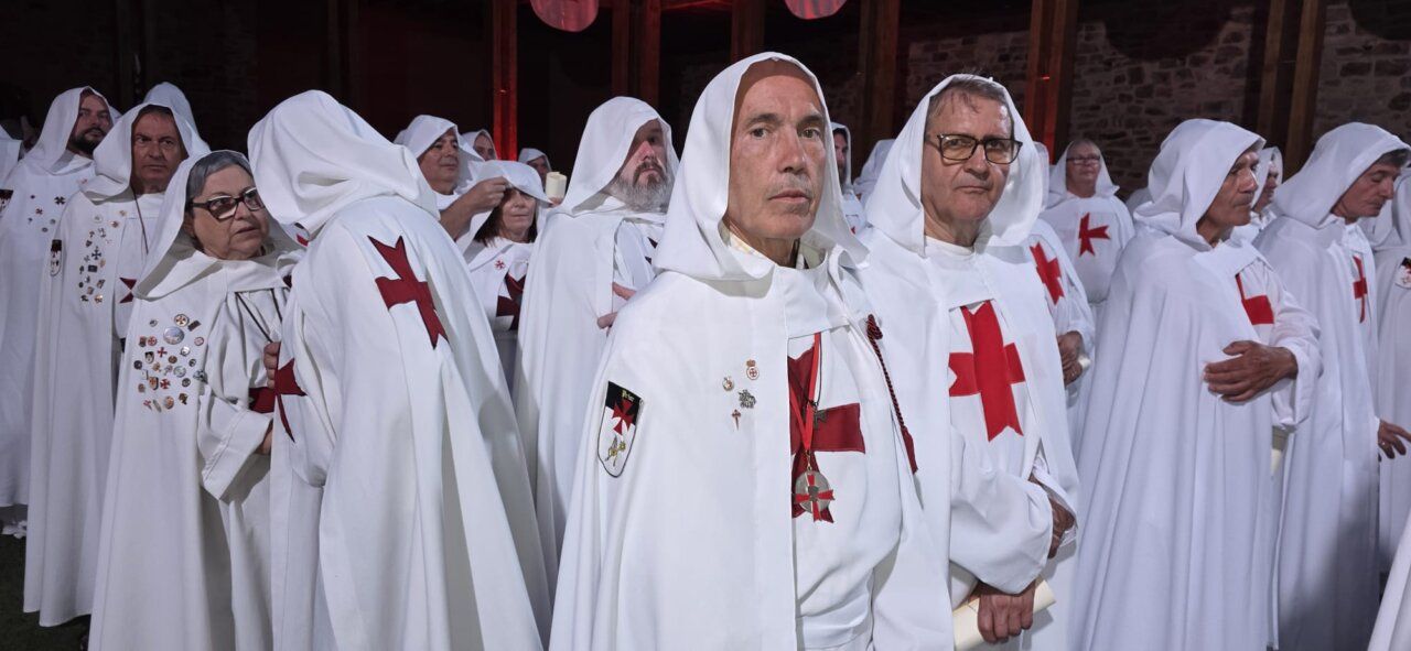 Ceremonia de ordenación templaria con participantes en túnicas blancas