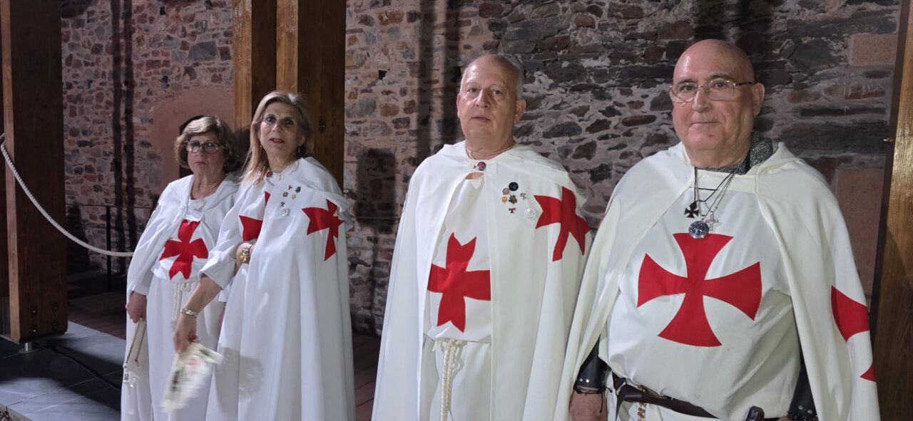 Cuatro personas vestidas con túnicas de la orden templaria