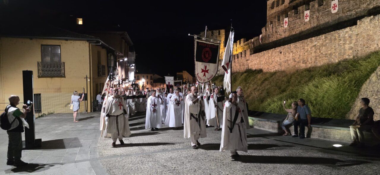Desfile de templarios en la noche con banderas y trajes tradicionales