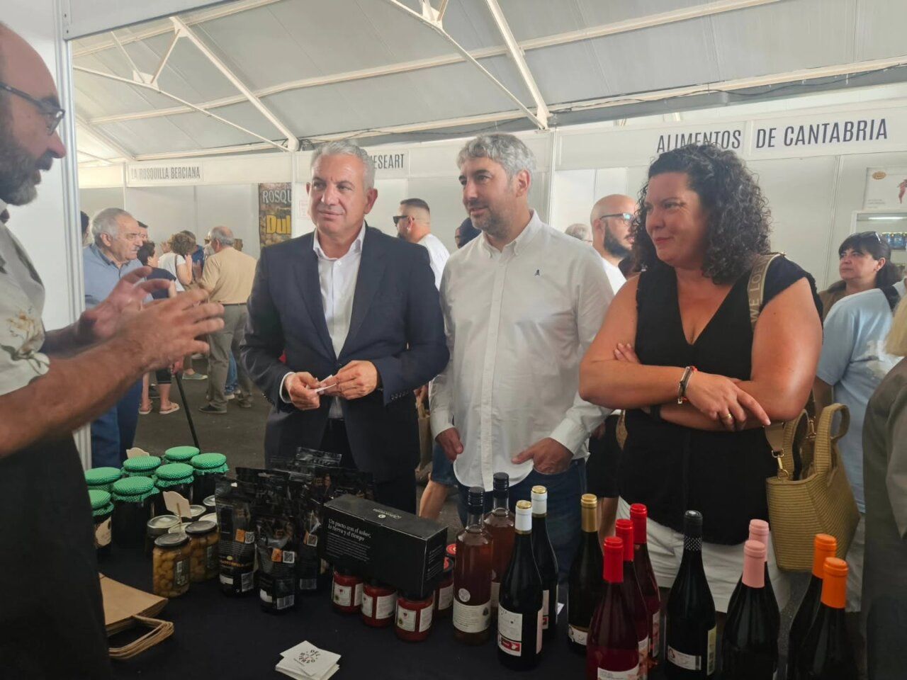 Asistentes conversando en la Feria de El Espino con productos locales