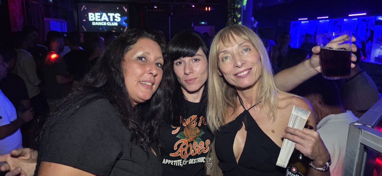 Tres mujeres sonrientes en Beats Dance Club durante una fiesta