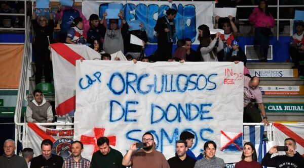 Aficionados sosteniendo pancarta en el evento de entrenamientos