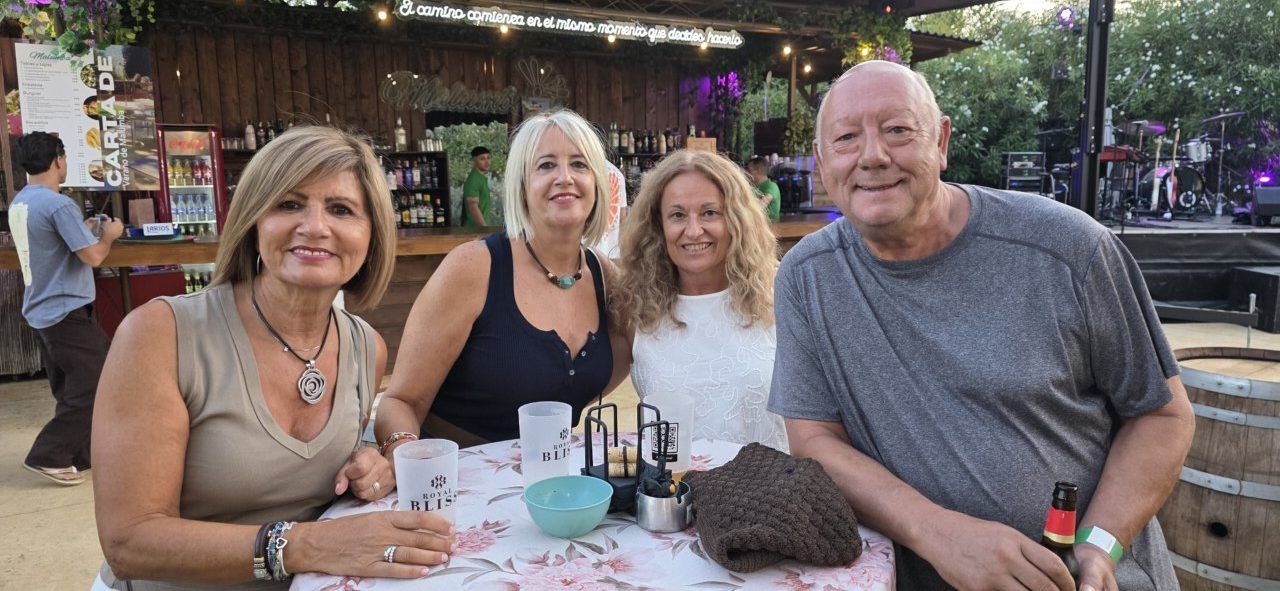 Cuatro personas disfrutando de un concierto en la terraza Malumba