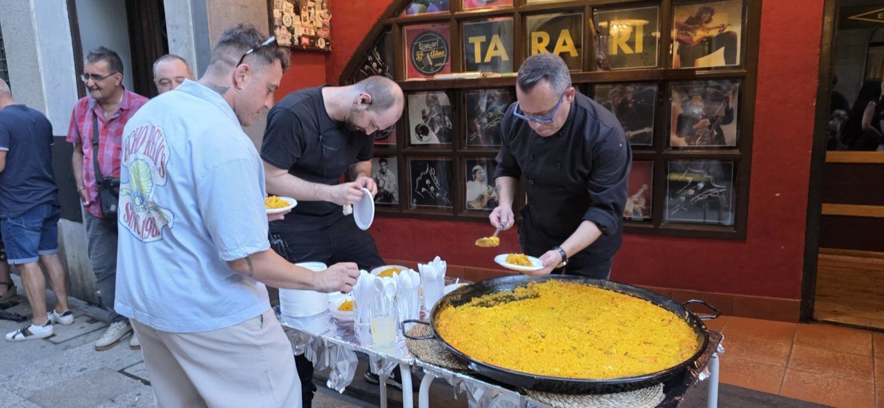 Personas sirviendo paella en la celebración del aniversario de la Sala Tararí