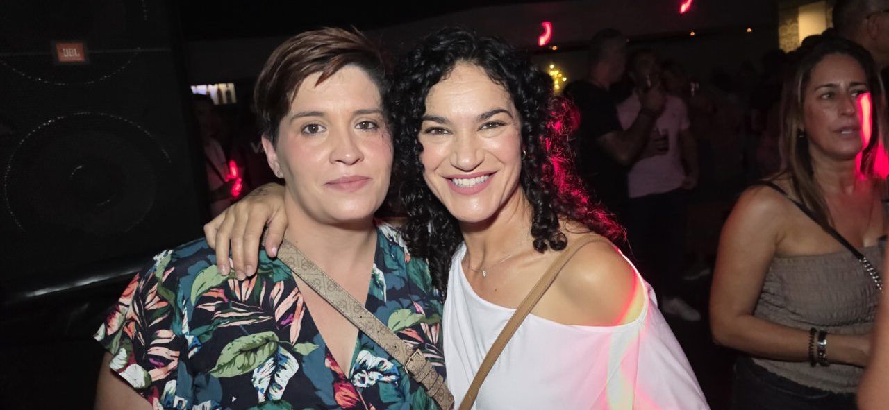 Dos mujeres sonrientes en la fiesta de los 80 y 90 en Ponferrada