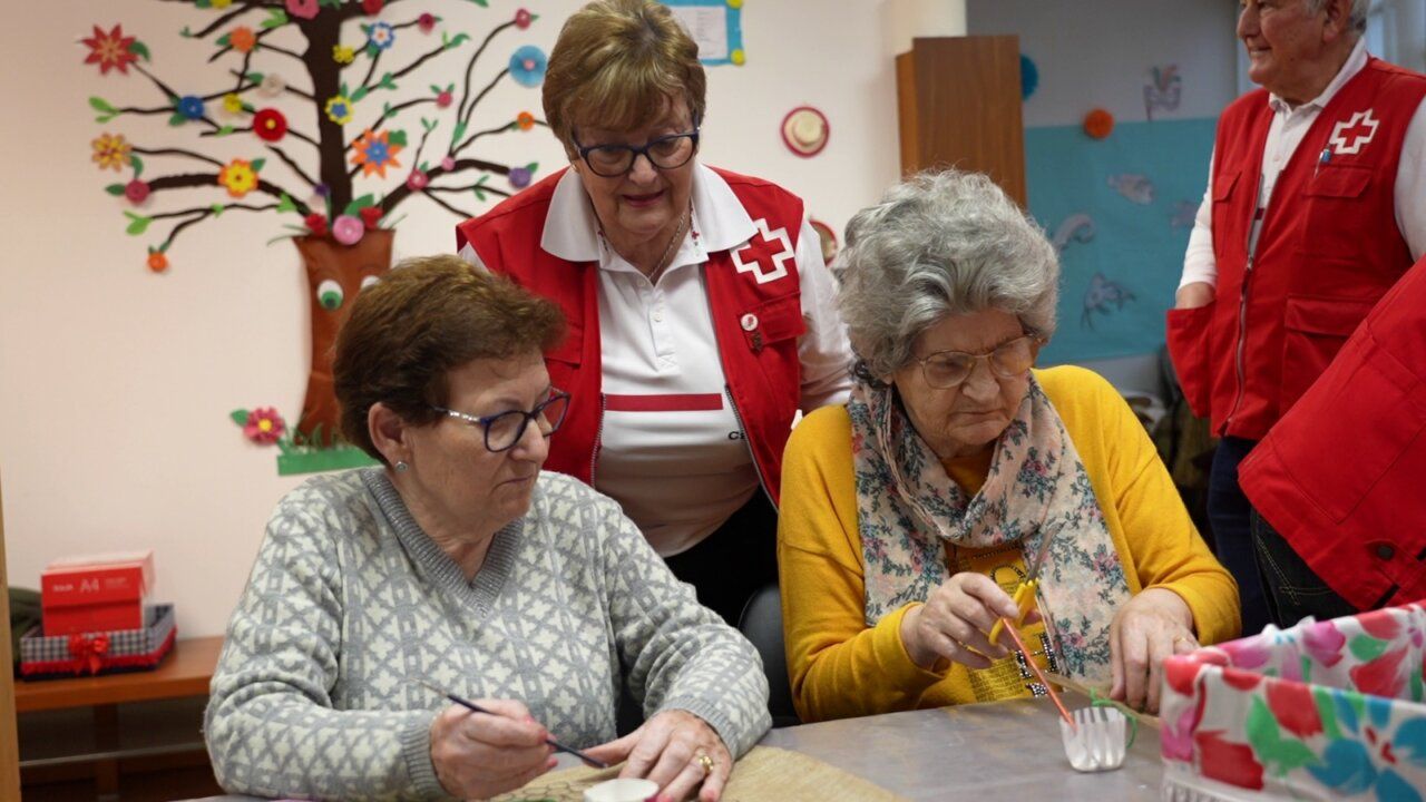 Personas mayores participando en actividad con voluntarios de Cruz Roja