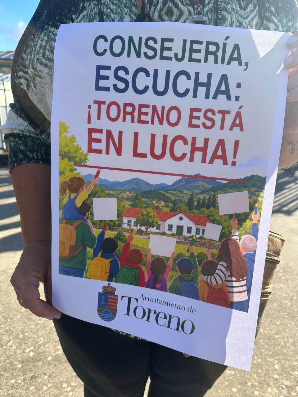 Persona sostiene un cartel sobre la lucha educativa en Toreno