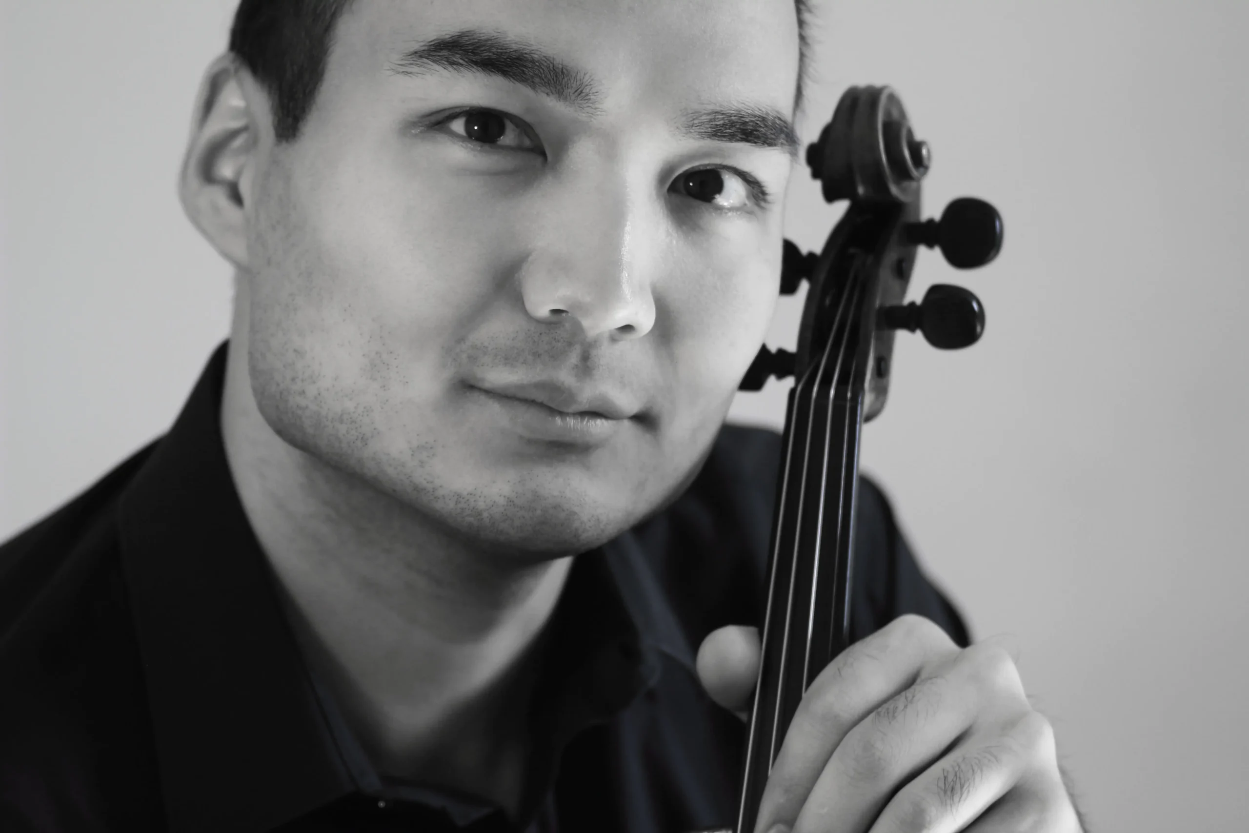 Erzhan Kulibaev sosteniendo un violín en un retrato en blanco y negro