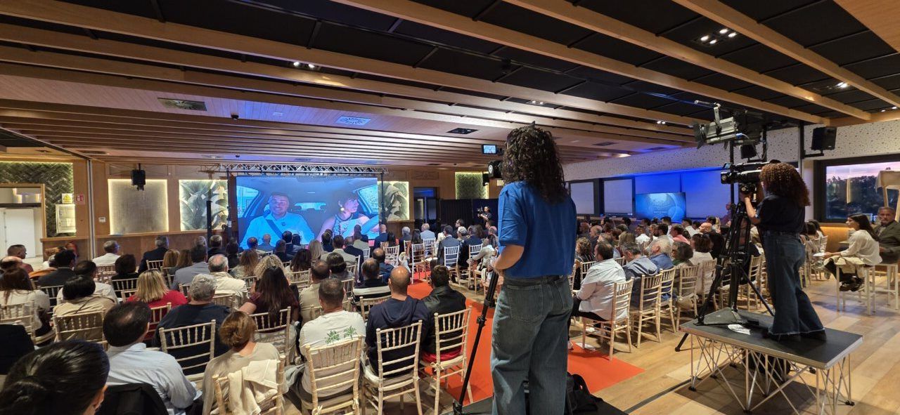 Asistentes a una conferencia en un salón con proyector
