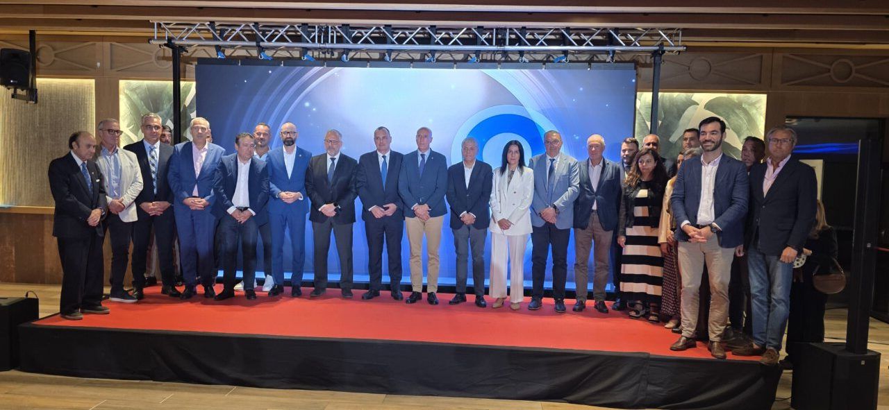 Grupo de personas posando en un evento en León con fondo decorativo