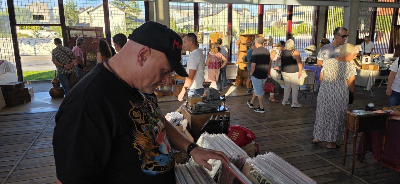 Visitantes explorando puestos en la II Feria de Antigüedades en Ponferrada