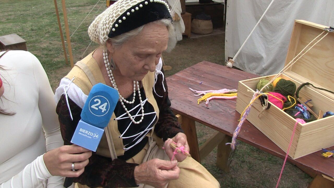 Mujer mayor tejiendo en evento sobre la batalla de los Irmandiños