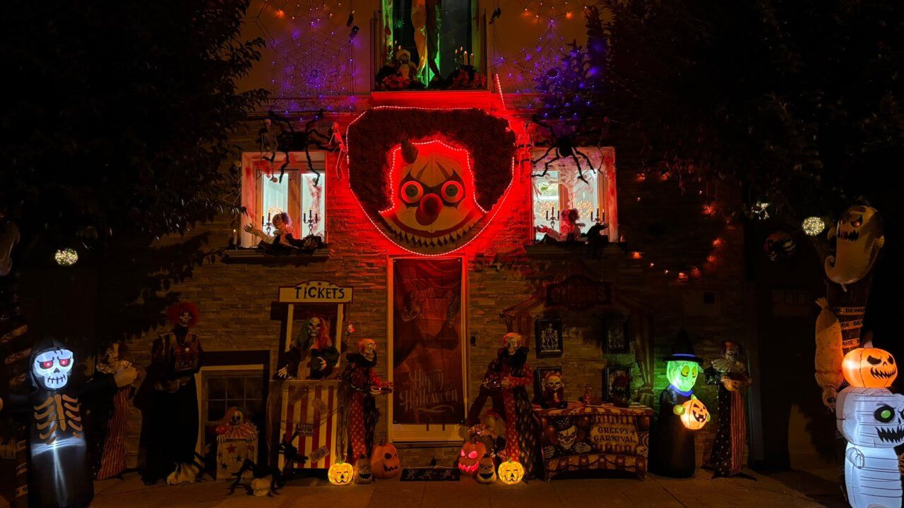 Fachada de una casa decorada con figuras y luces de Halloween