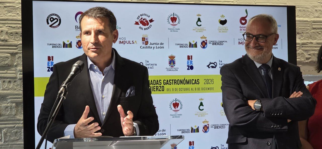 Dos hombres en un acto de las Jornadas Gastronómicas del Bierzo, junto a un micrófono.