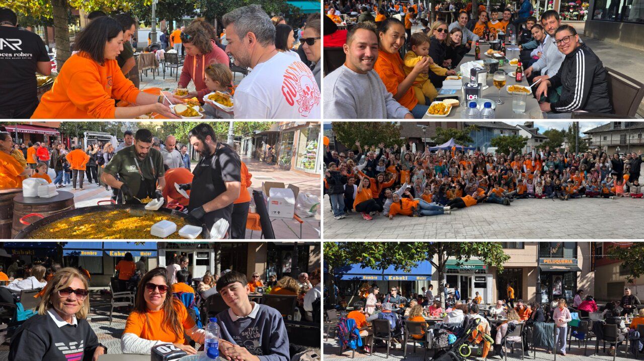 Participantes de una marcha solidaria comparten comida y posan juntos en una plaza.